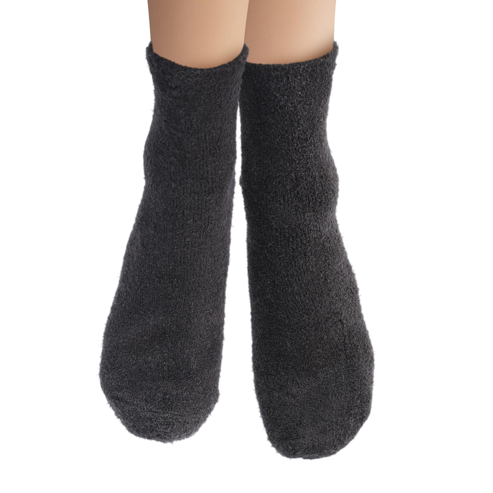 Earth Therapeutics aloe vera socks next to foot lotion illustrating improved lotion absorption