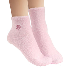 Earth Therapeutics aloe vera socks with lotion being applied to foot to enhance absorption