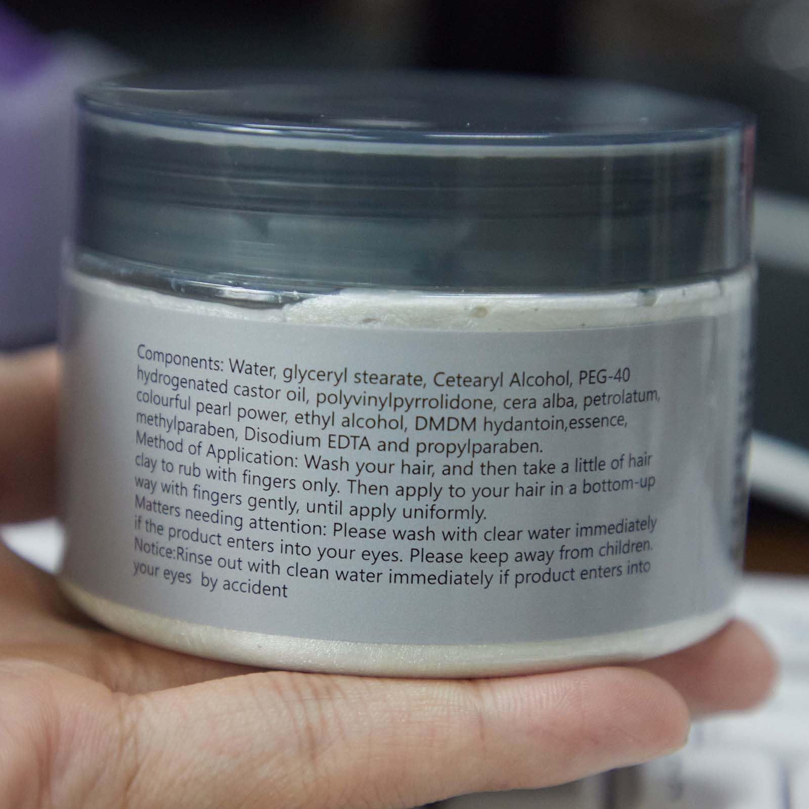 EFLY jar in hand displaying 4.23 oz size, showing scale and travel-friendly benefit