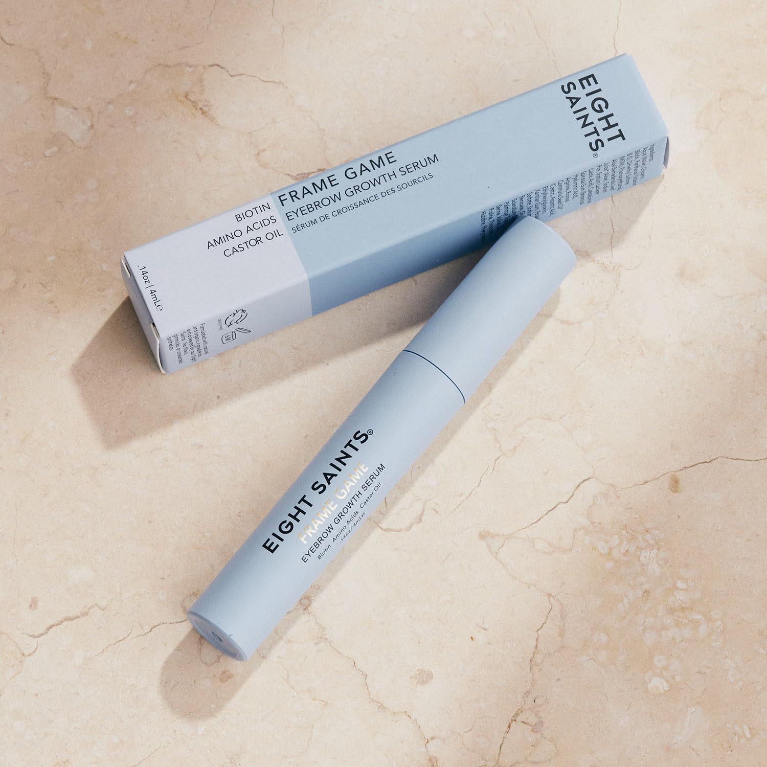Person applying Eight Saints serum to brows for targeted conditioning