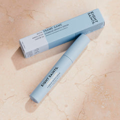 Person applying Eight Saints serum to brows for targeted conditioning