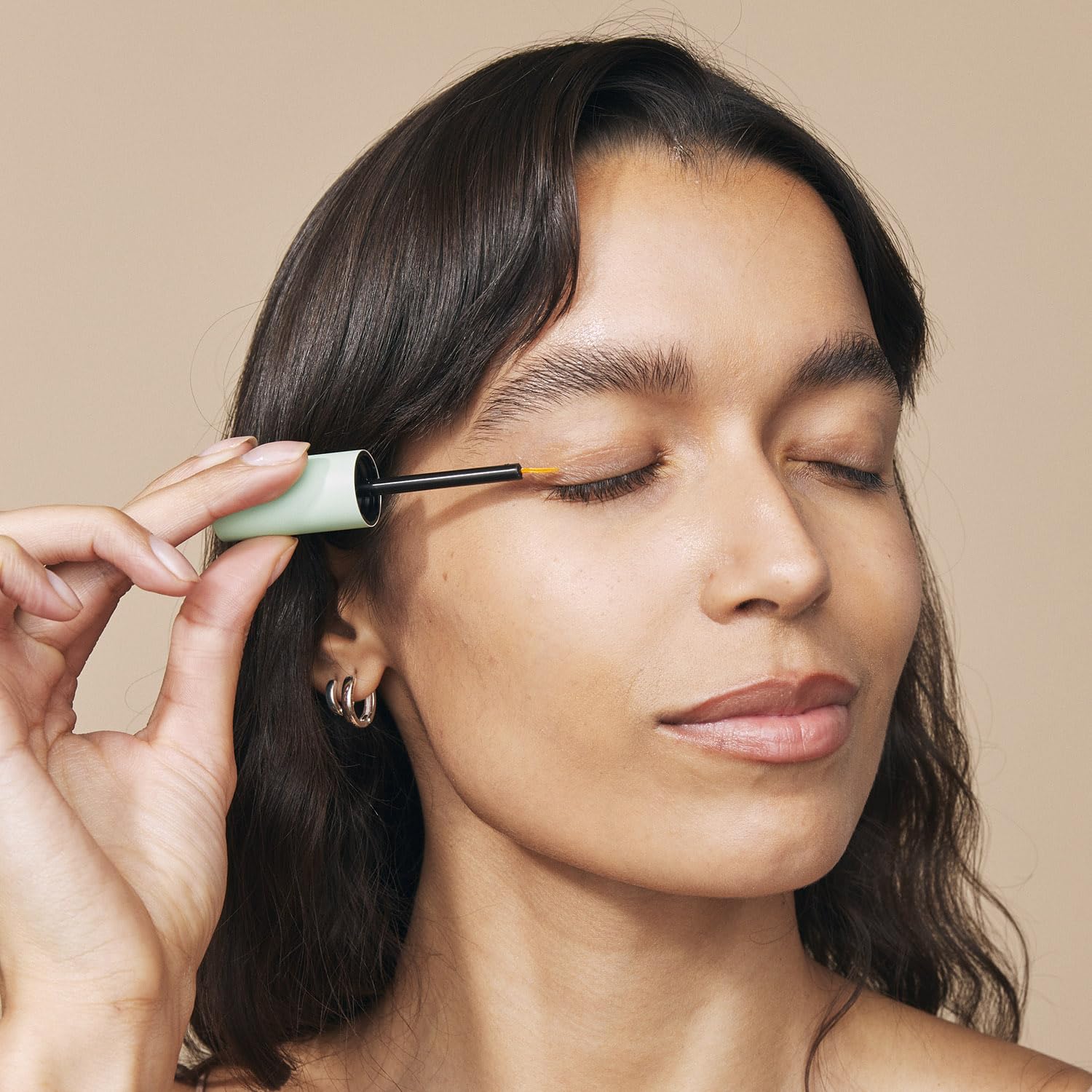 Eight Saints serum droplet on finger highlighting lightweight hydrating texture