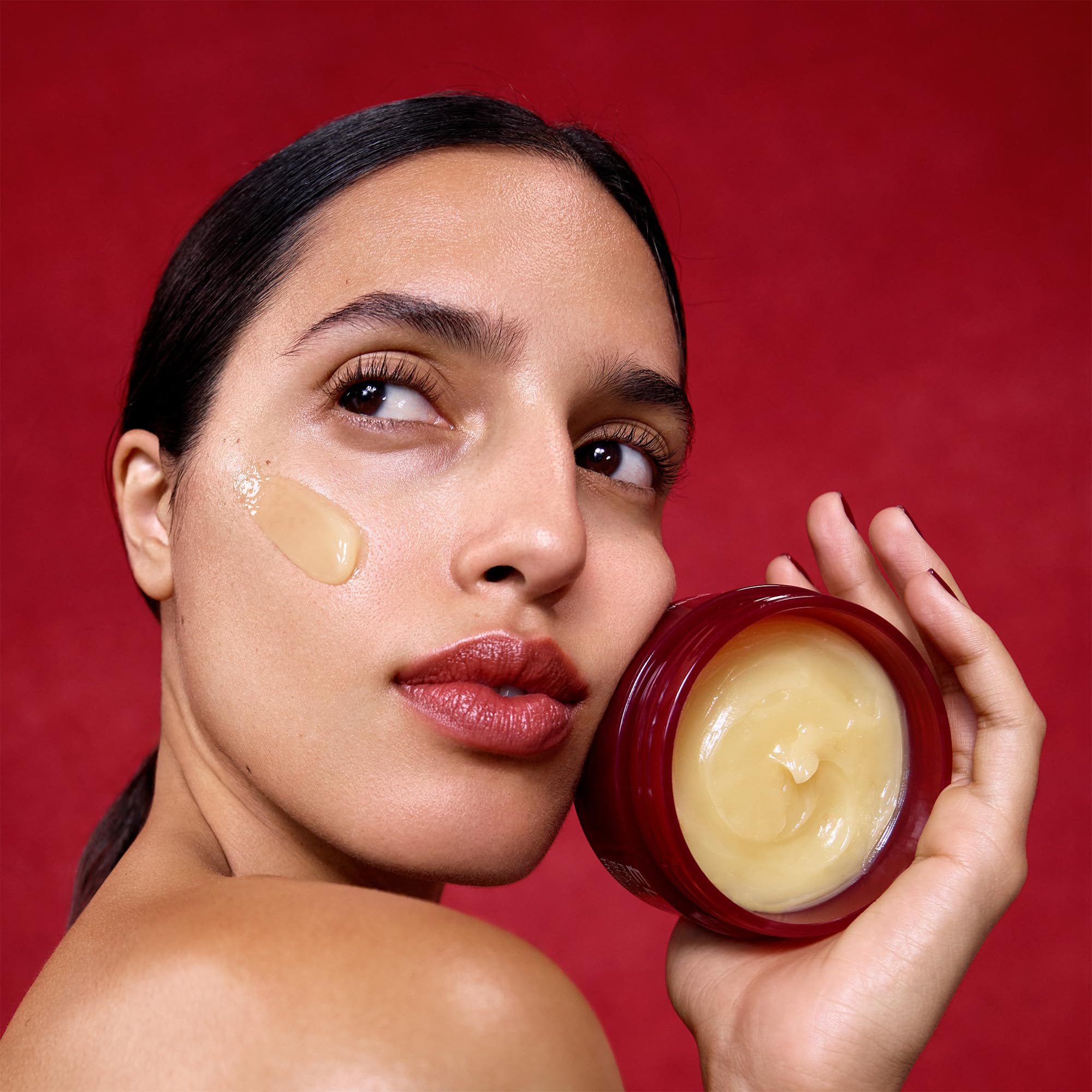 ELEMIS balm next to hand showing 100g scale and travel-friendly benefit