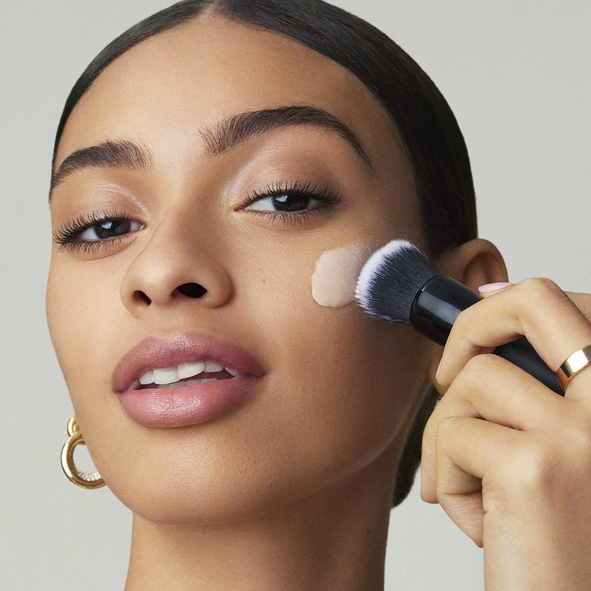 e.l.f. primer smoothed on nose and cheek to show visible pore-blurring effect