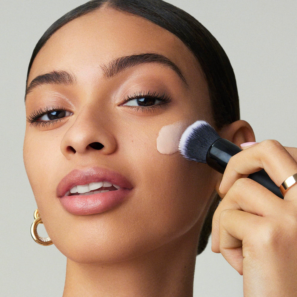e.l.f. primer smoothed on nose and cheek to show visible pore-blurring effect
