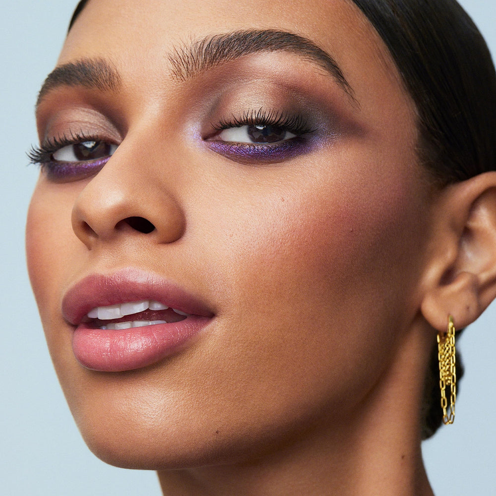 e.l.f. Perfect 10 size scale beside a brush showing travel-ready compact benefit