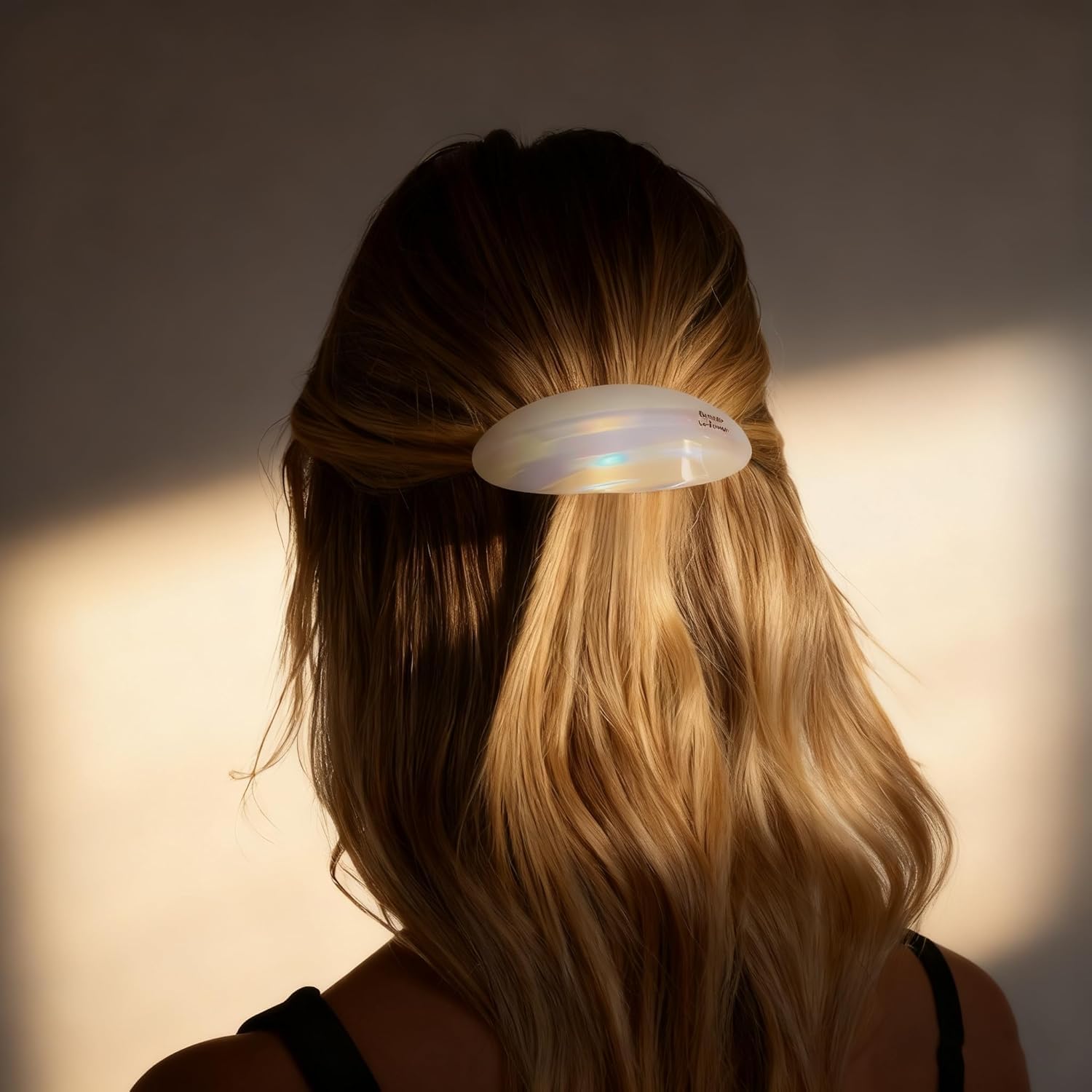 Eliongpu barrette next to a hand for size comparison showing ample coverage benefit