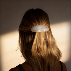 Eliongpu barrette next to a hand for size comparison showing ample coverage benefit