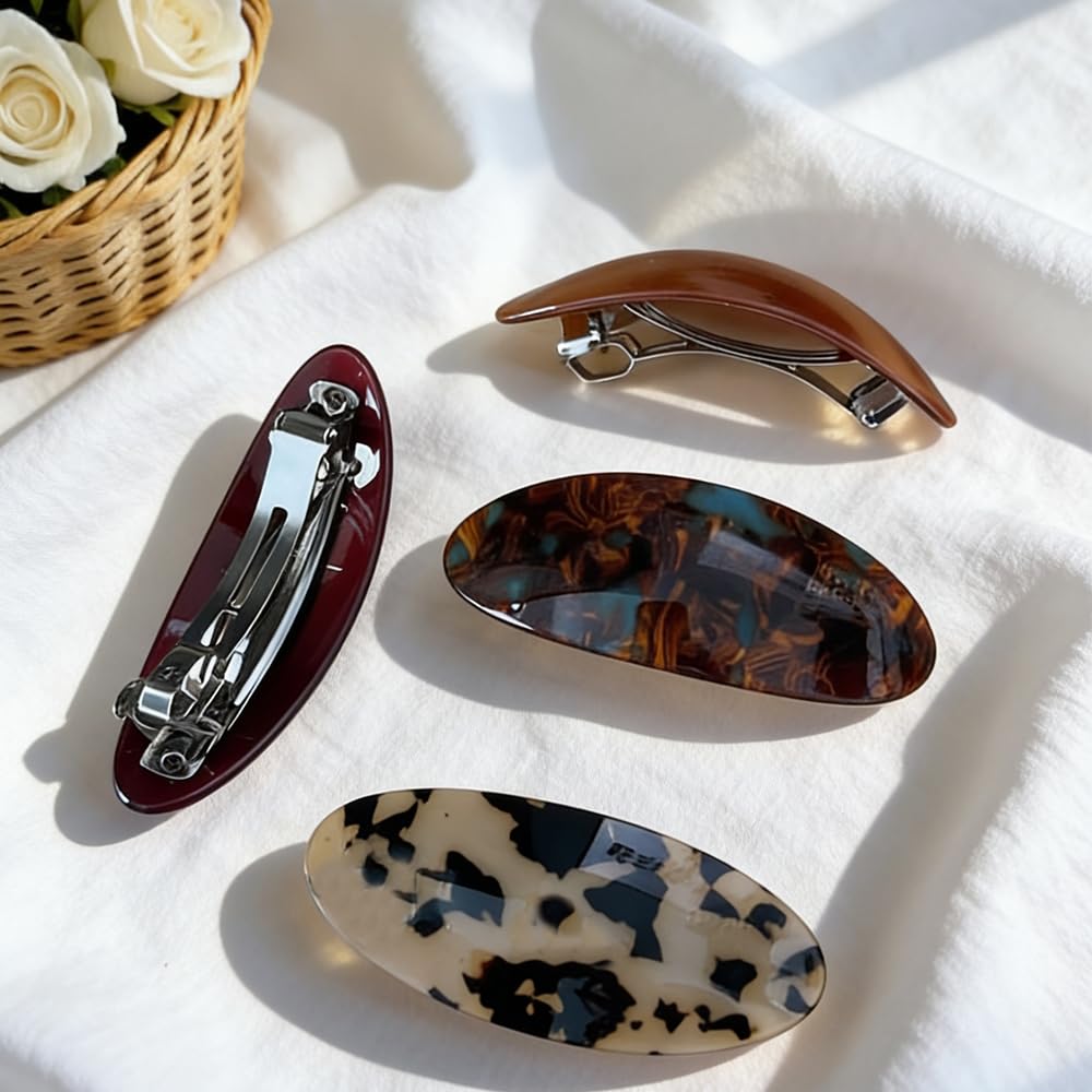 ELLOPH barrette beside a hand for scale to show large size and comfortable grip