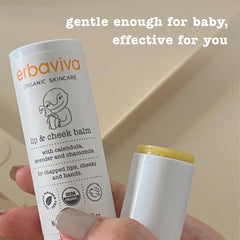 erbaviva tube next to adult hand and coin for scale, communicates compact size and portability