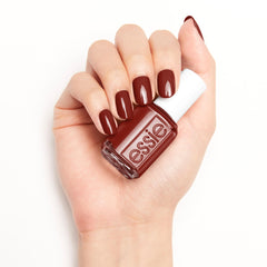 essie bottle paired with cuticle oil promoting healthier nail routine