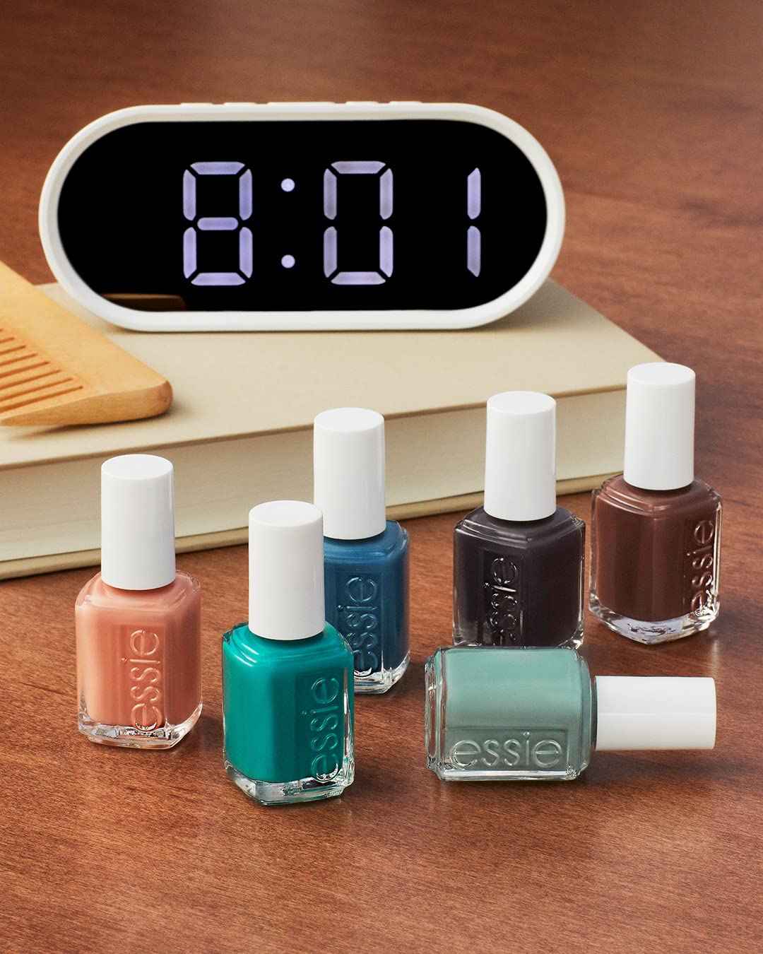 essie polish beside apricot cuticle oil suggesting maintenance and longer wear