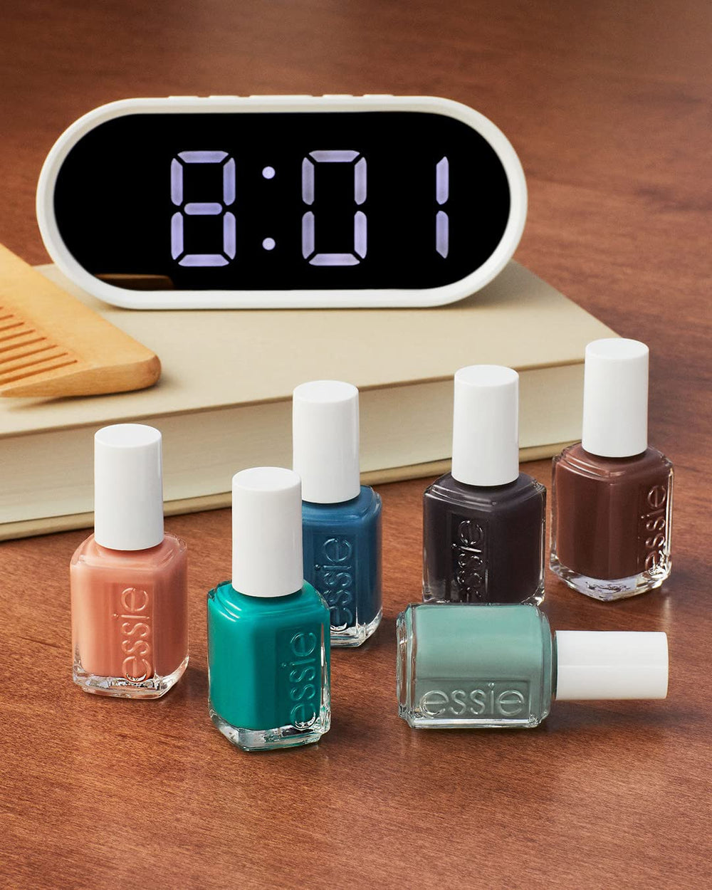 essie polish beside apricot cuticle oil suggesting maintenance and longer wear