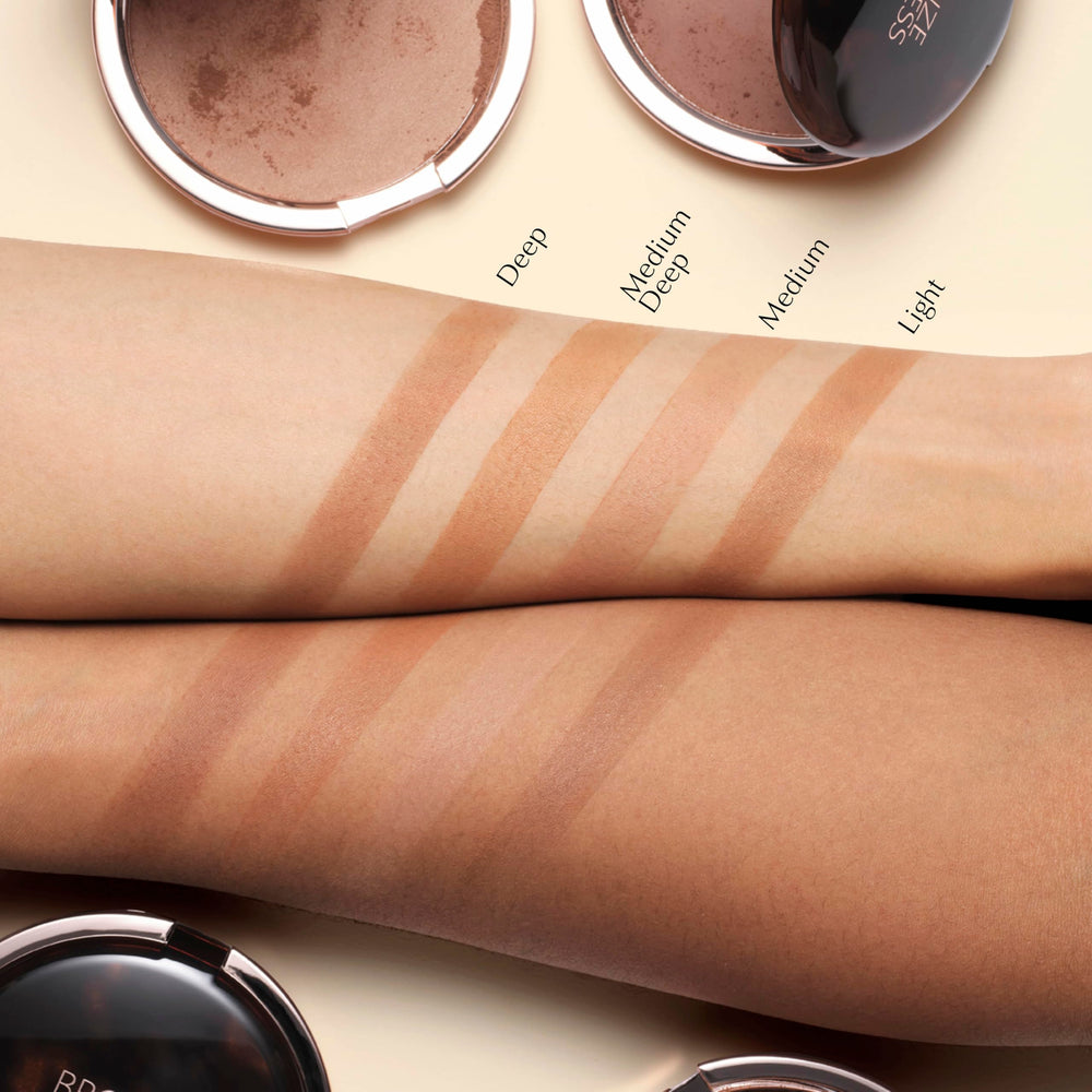Estée Lauder bronzer being applied with brush to cheek demonstrating buildable natural color