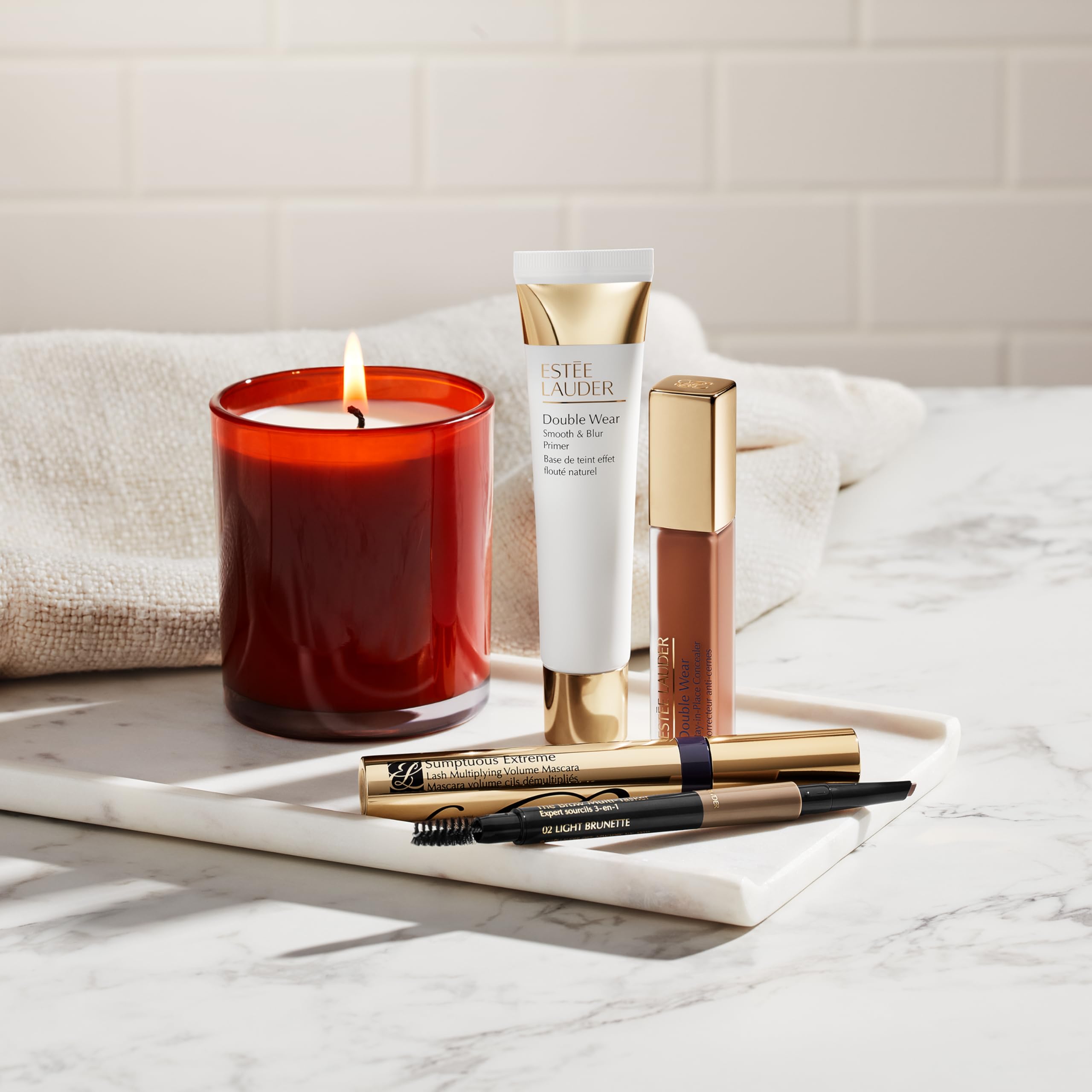 Estée Lauder spoolie brushing brows in use to blend and set benefit