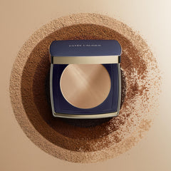 Estée Lauder compact beside coin for scale and travel-friendly convenience