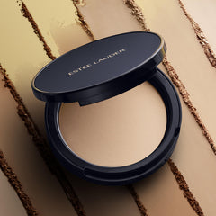 Estée Lauder compact beside coin illustrating portable size and on-the-go touch-ups