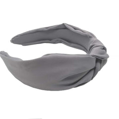 Etercycle headband next to a hand showing size and portable convenience for travel