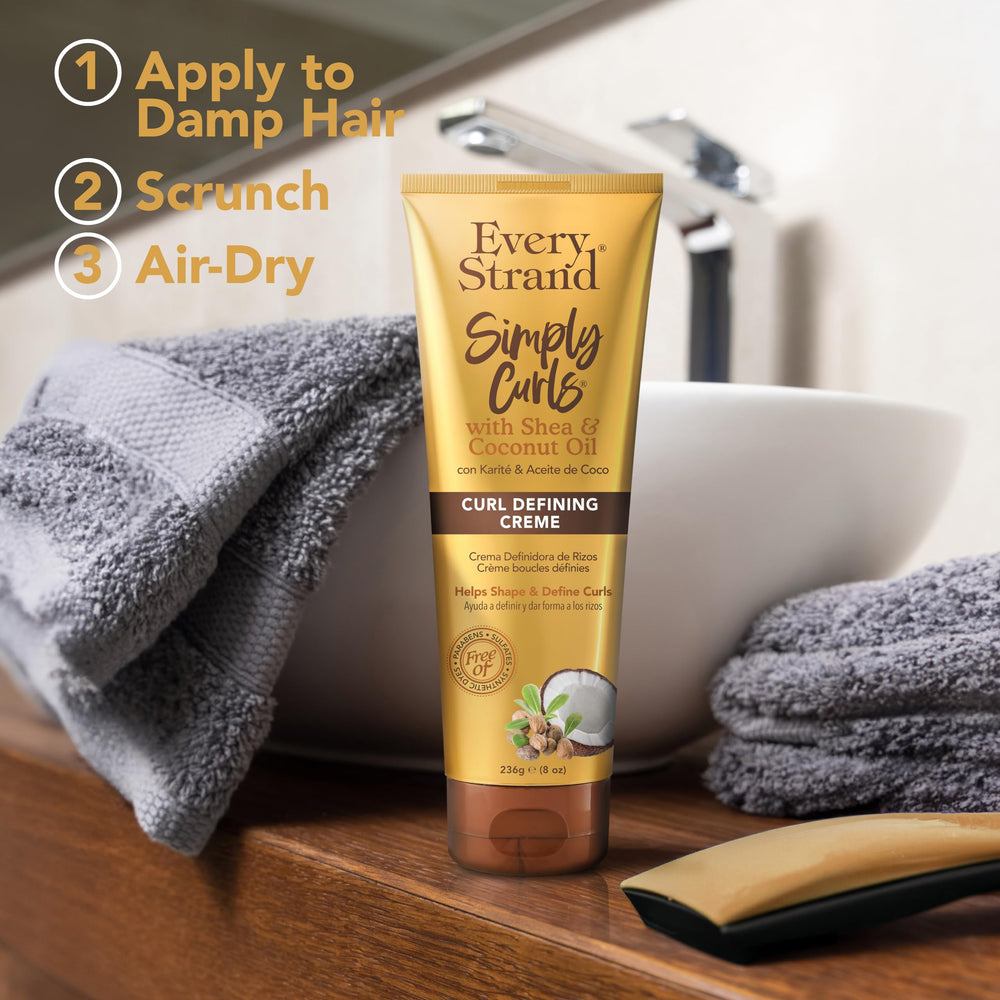 Applying Every Strand cream to wet hair to boost curl definition