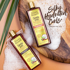 Every Strand bottles in-shower being applied to wet curly hair