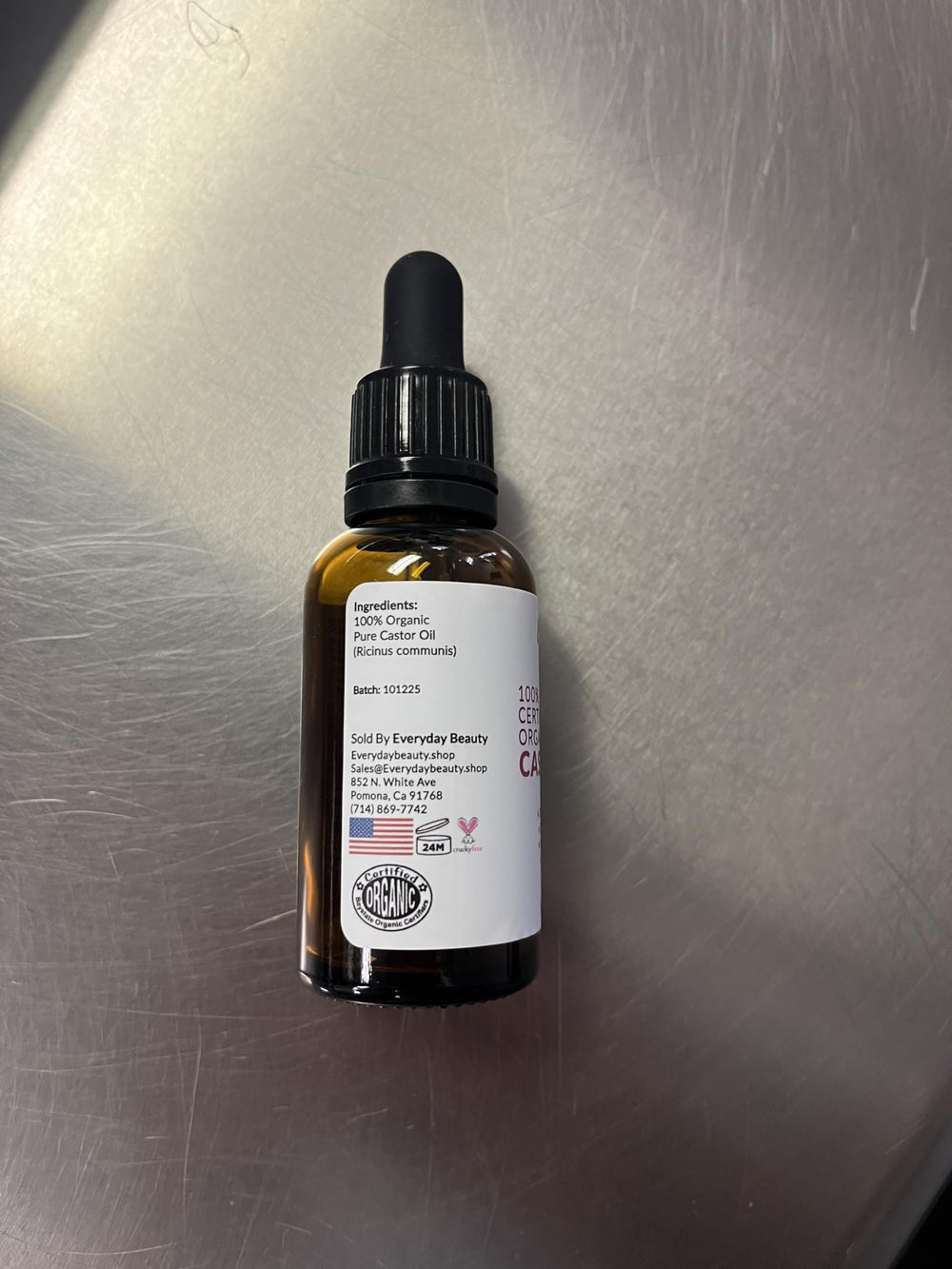 Everyday Beauty castor oil pack laid on cloth in lifestyle setting for wellness