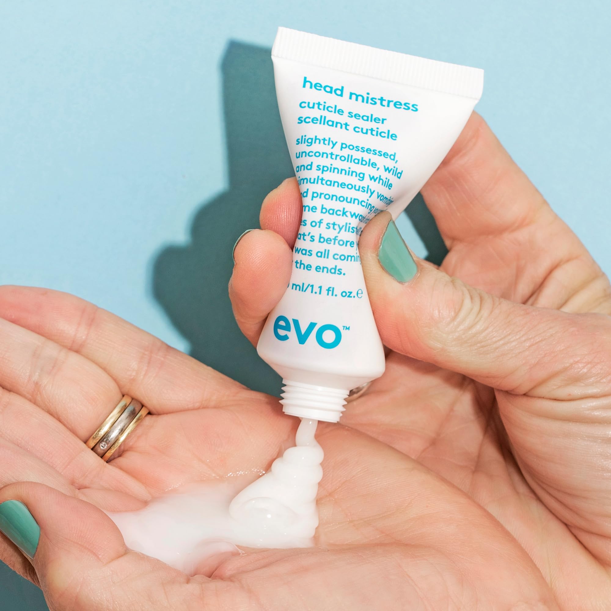 EVO Head Mistress held in hand to show 1 fl oz size and portability