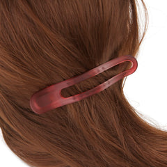 EWSNM clip holding thick hair section demonstrating strong clamp benefit