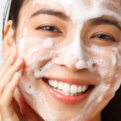EXUVIANCE hand applying cleanser showing makeup removal and smooth application