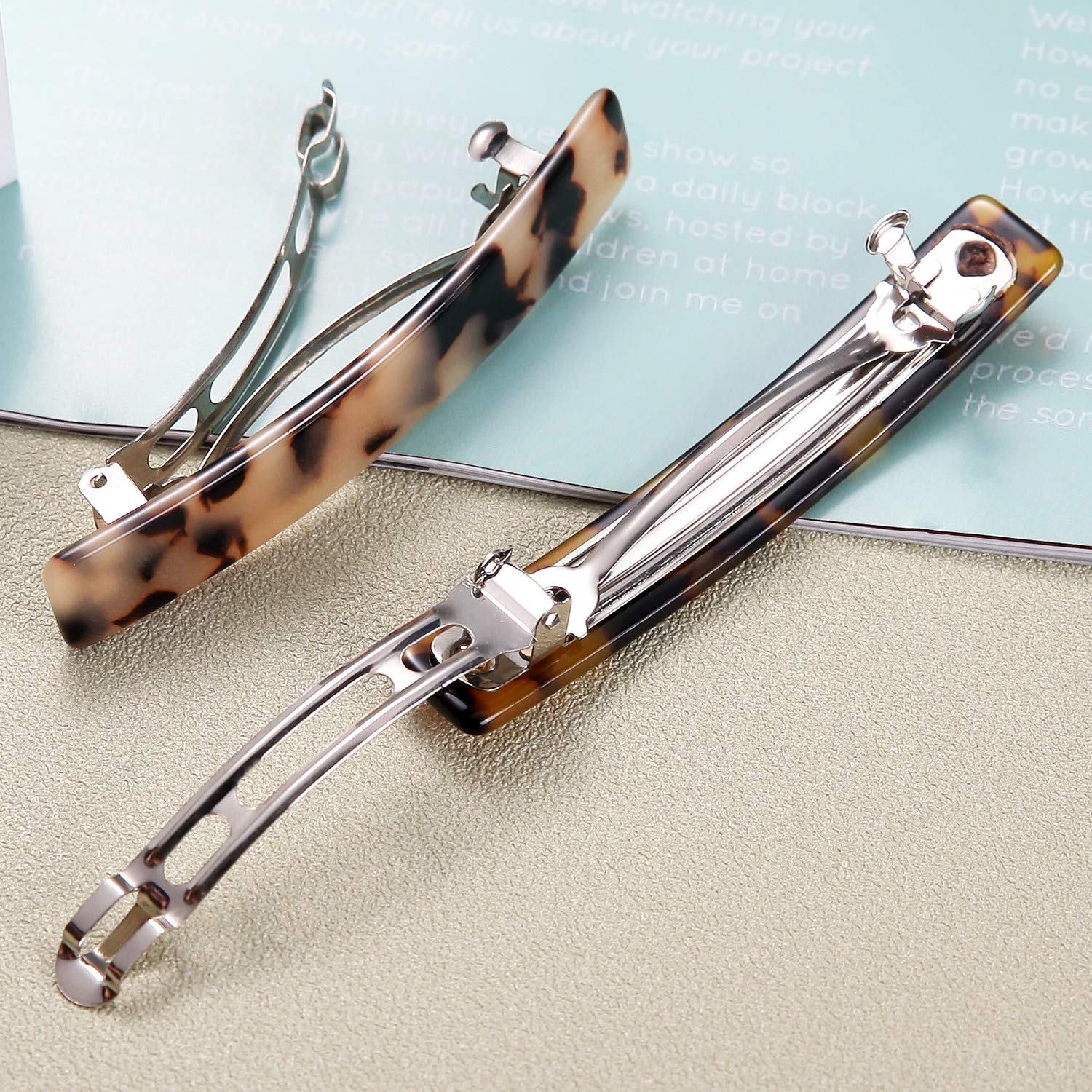 Eyegla gift box open with two barrettes neatly presented, ready for gifting