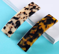 Eyegla worn in half-up hairstyle delivering elegant hold and polished look