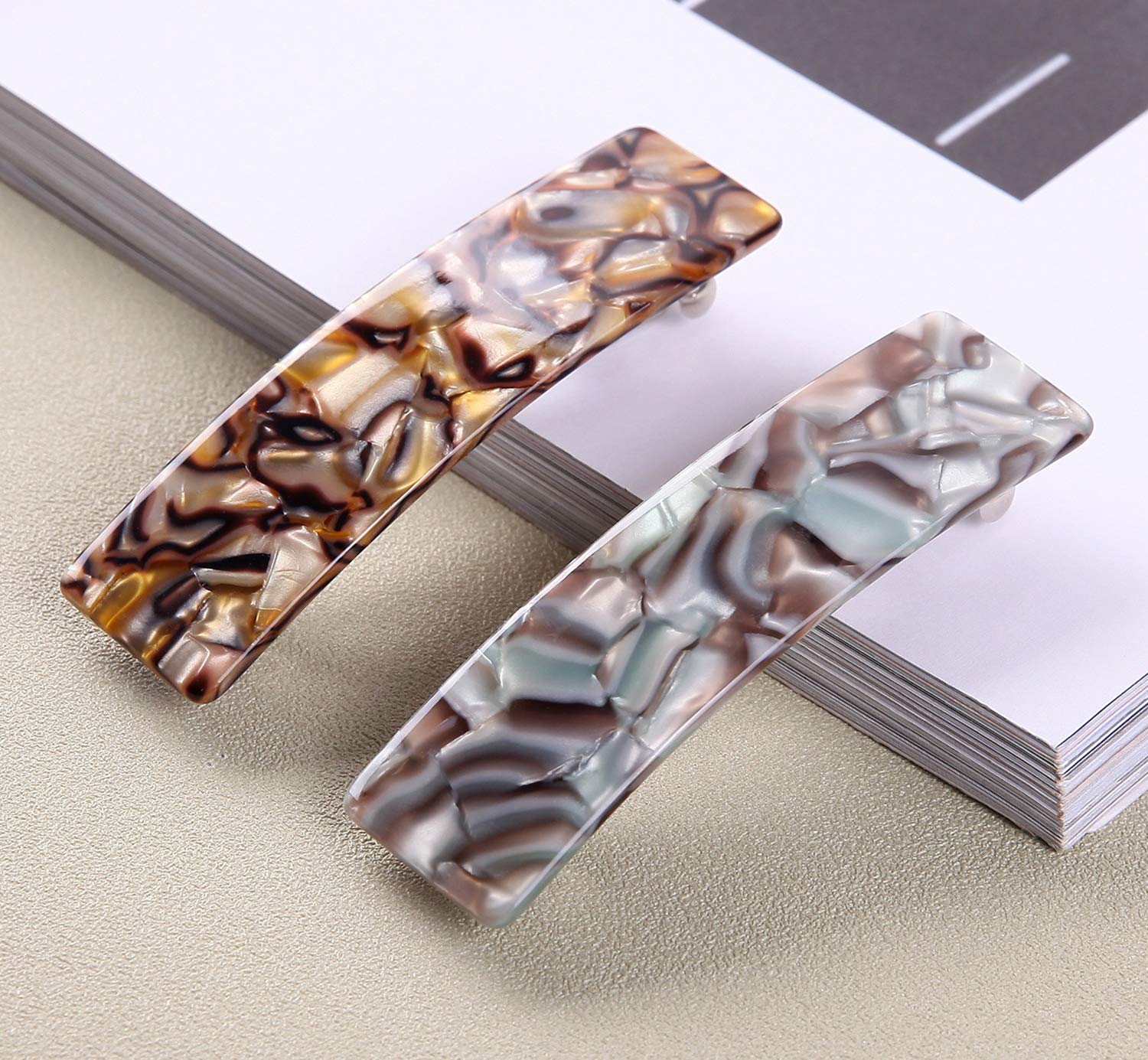 Eyegla barrettes in hand to show scale and comfortable lightweight benefit