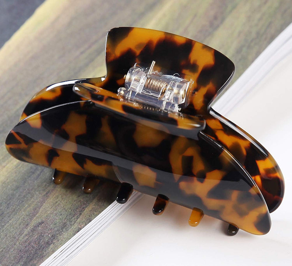 Eyegla clip beside hand showing 3.75-inch scale for full hair coverage