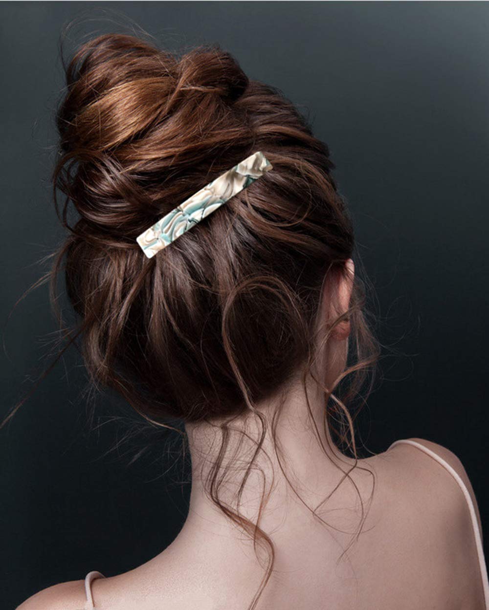 Eyegla barrette next to a ruler showing 3 inch size and easy portability benefit
