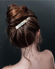 Eyegla barrette next to a ruler showing 3 inch size and easy portability benefit