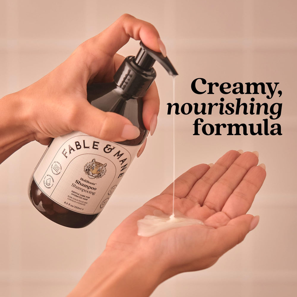 Fable & Mane bottle held by hand showing product size and portability