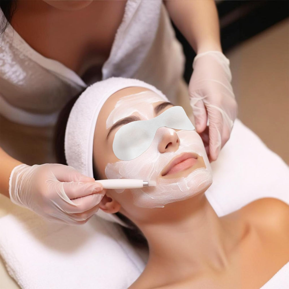 FdcLixuvol eye covers on bathroom vanity next to skincare products for home spa