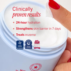 First Aid Beauty jar open with scoop of product highlighting creamy, non-greasy feel