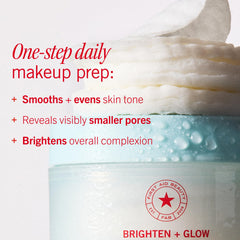 Hand holding a pad beside fingers for scale showing First Aid Beauty pads are easy to use and travel-ready