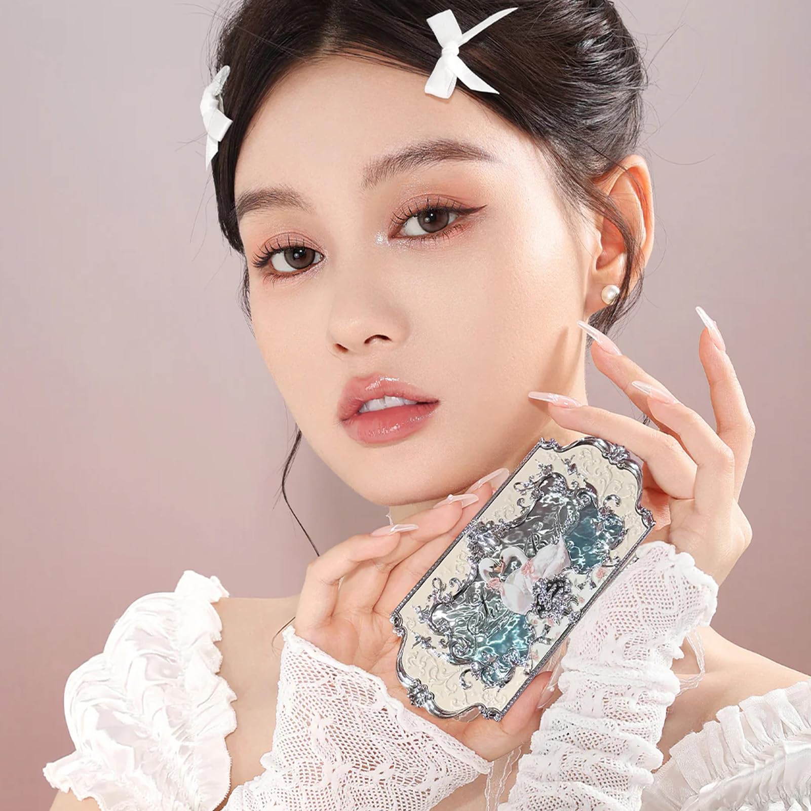 Flower Knows engraved swan and skirt detail highlighting decorative compact art
