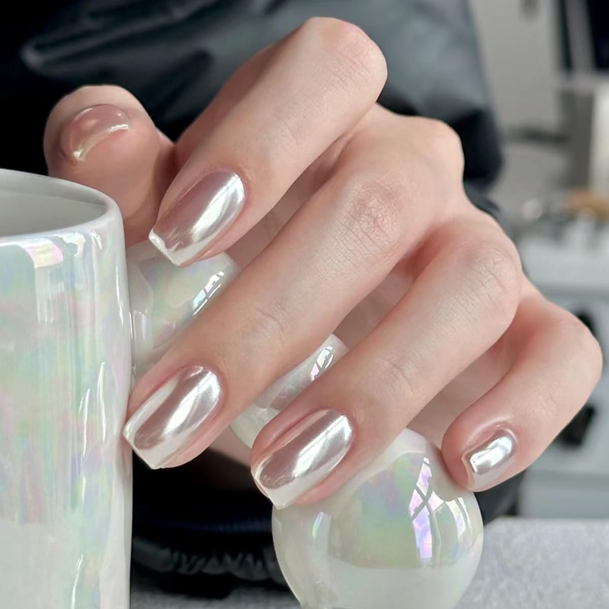 Fokostar 0.5g jar beside fingers illustrating compact size and travel convenience