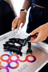 FRAMAR clip holding section of hair during styling for secure control