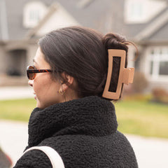 FRAMAR four neutral colored clips styled on a table illustrating outfit-matching options