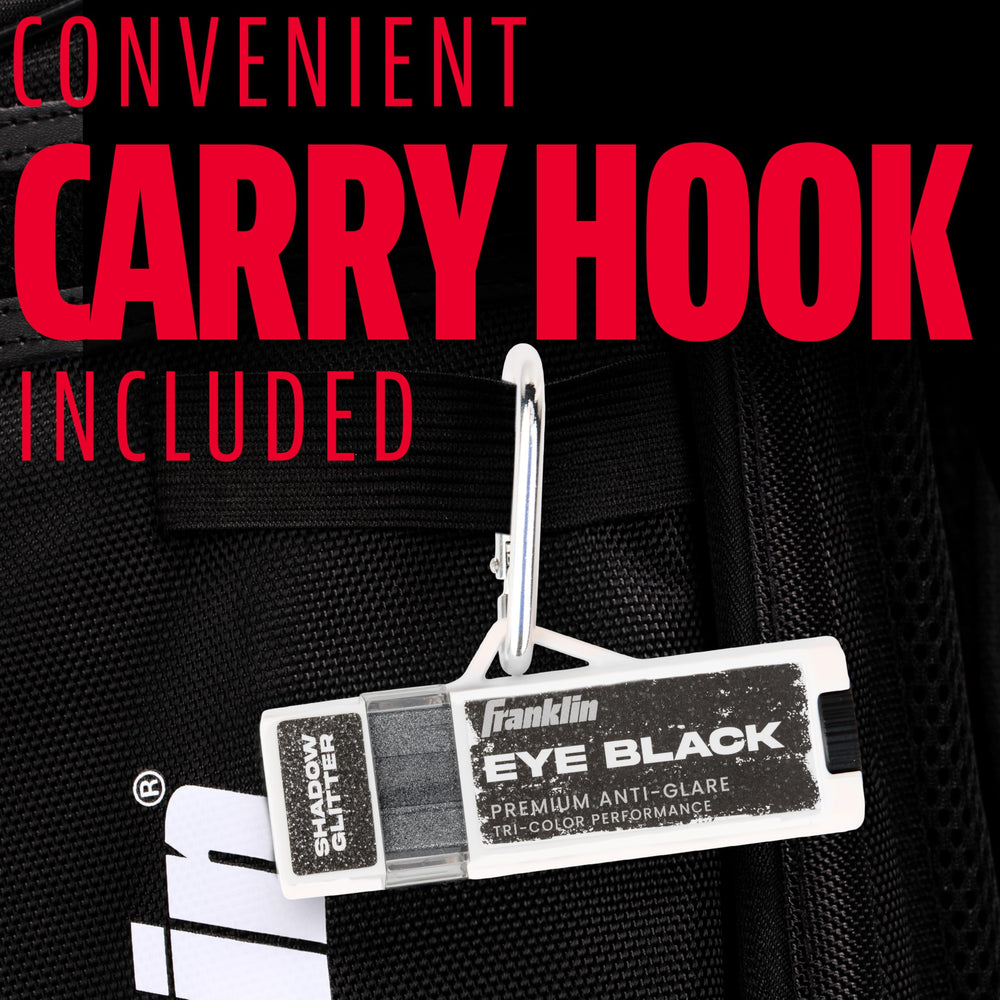 Franklin Sports eye black stick next to glove showing compact travel size