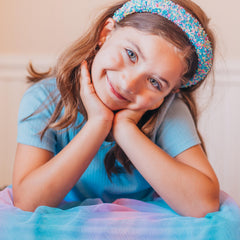 FROG SAC headband in hand bending slightly to show flexible hoop for comfortable wear