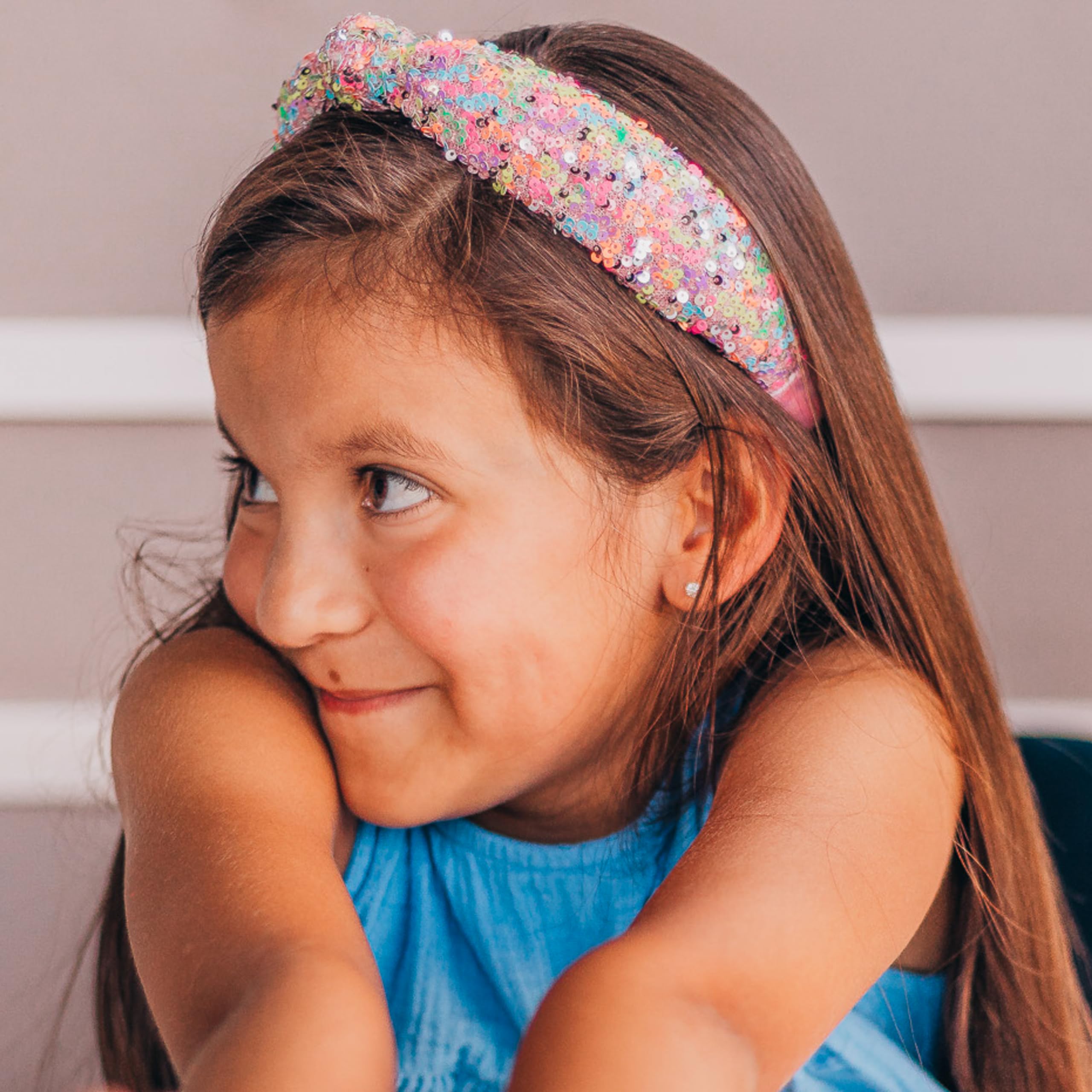 Child wearing FROG SAC headband at school showing secure hold and playful style