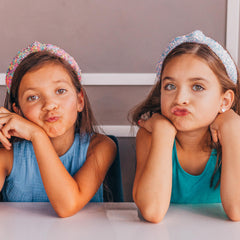 Girl wearing FROG SAC headband at a party showing festive sparkle and confidence