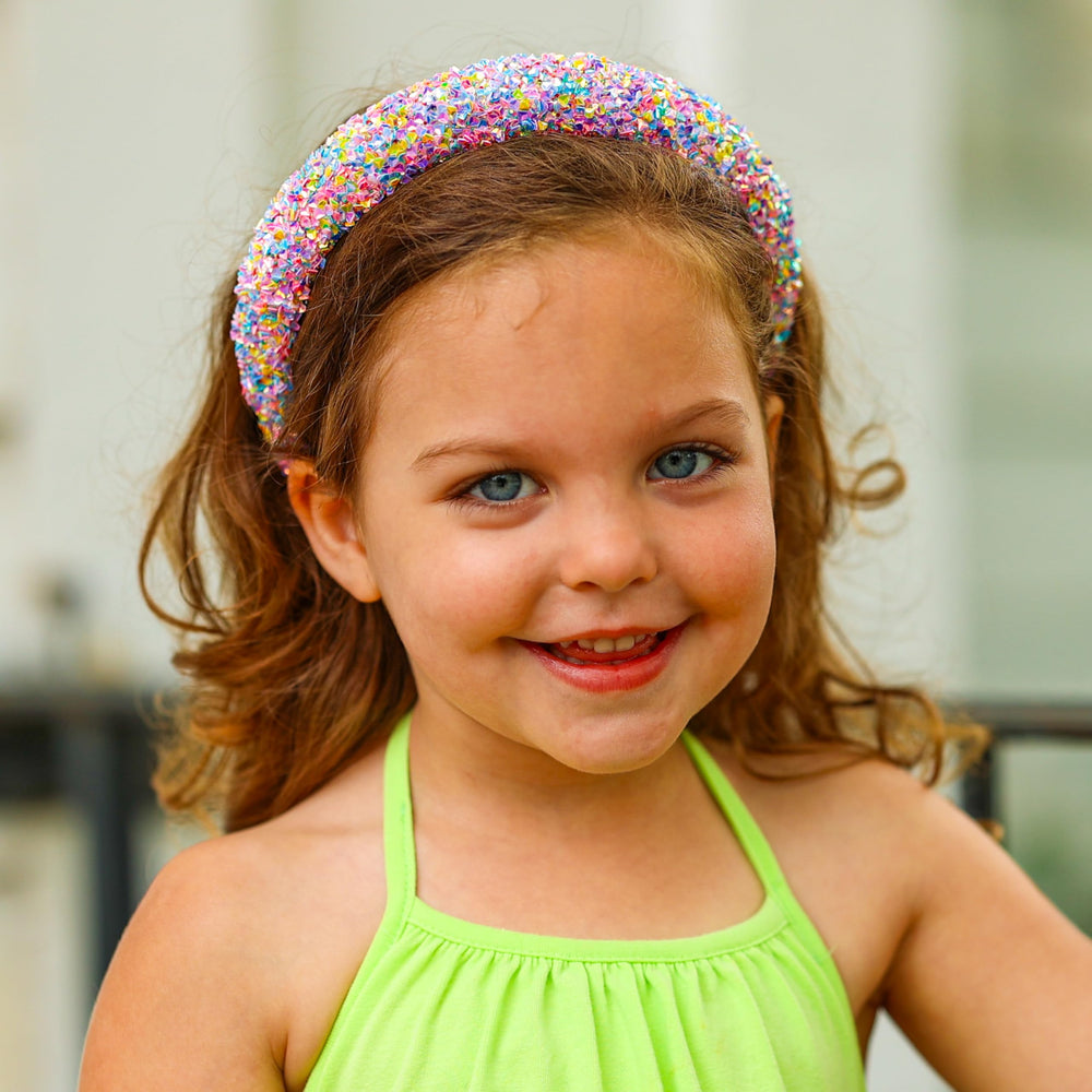 FROG SAC headband worn by a child in lifestyle setting adding playful confidence