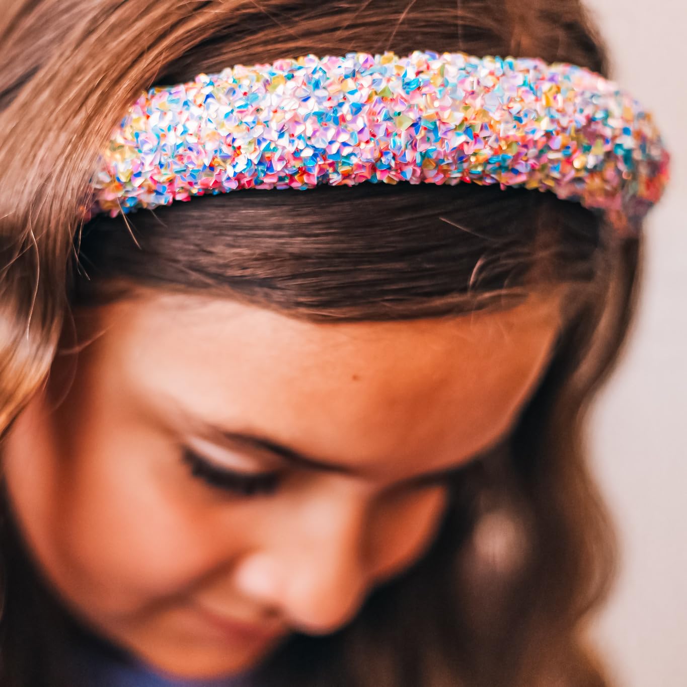 FROG SAC headband next to a hand showing scale and lightweight easy-to-wear benefit