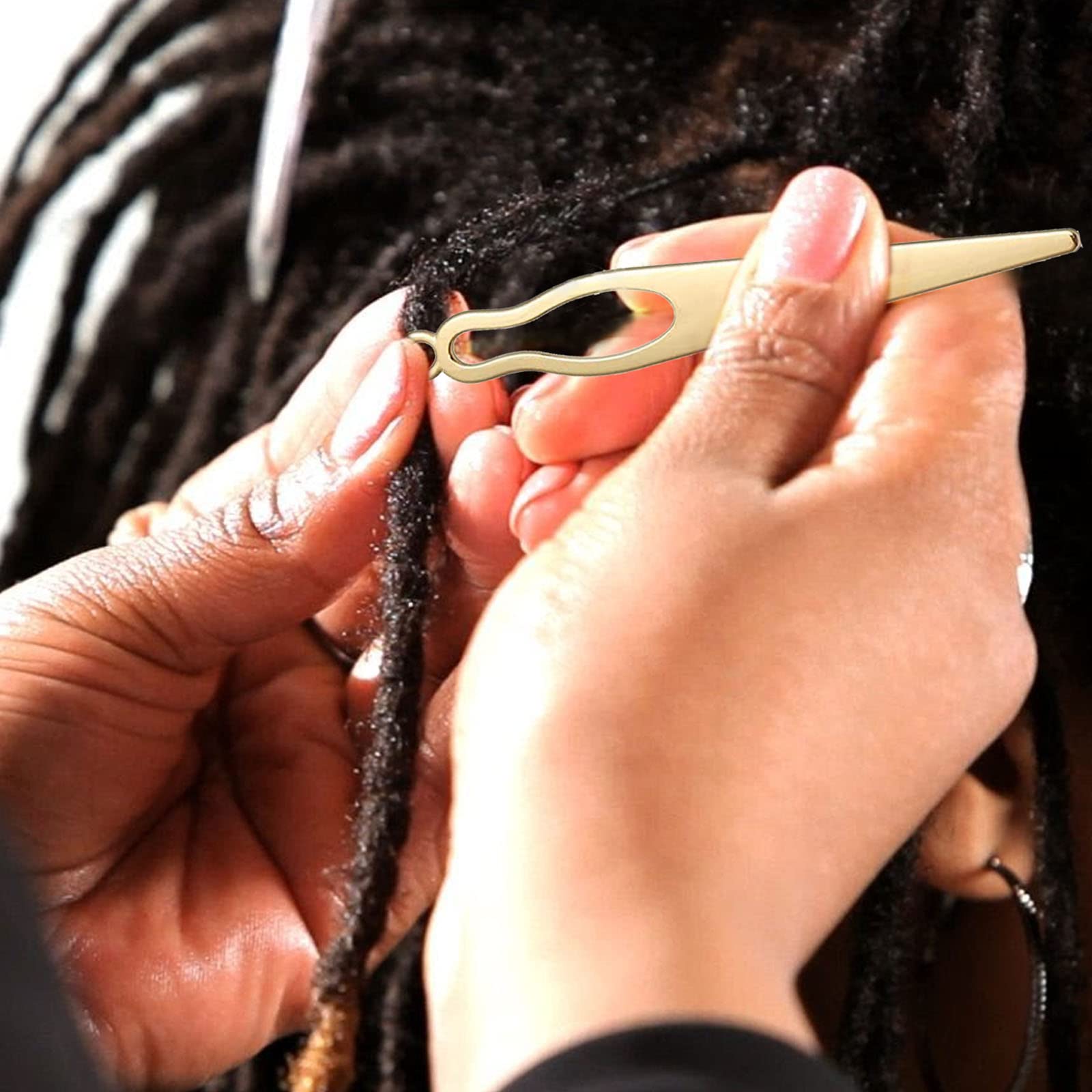 Frutain tool in use tightening a loc at the scalp for neat, secure maintenance