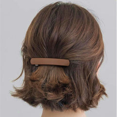 Fsmiling light blue barrette worn in hair adding subtle color and no-slip hold